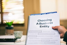 A notebook that says 'Choosing A Business Entity.' Learn the four key business entity types from our San Mateo employment law attorney today.