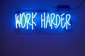 A sign that reads "Work Harder," if your employer is trying to change the terms of your employment, call our San Francisco law firm now.
