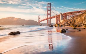 The Golden Gate Bridge at sunset with water and rocks. If you need representation for your discrimination case, contact the San Rafael discrimination attorneys at The Law Office of Jeannette Vaccaro.