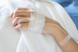 IV in a patient's hand in hospital bed, for FMLA Attorney San Francisco when wrongfully fired.