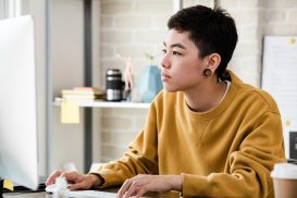 Person working at desk at work when misgendered on the job constantly meet with Oakland Discrimination Lawyer.